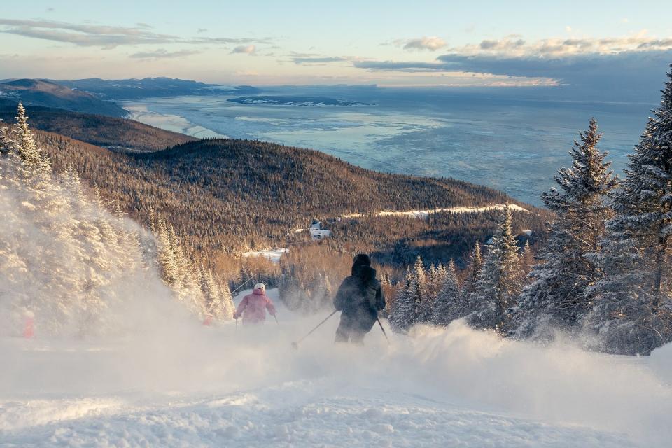 Skiers going down Club Med Mountain in Le Massif