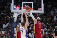 New Orleans Pelicans center Jonas Valanciunas (17) blocks a shot by Sacramento Kings forward Sasha Vezenkov (7) in the second half of an NBA basketball play-in tournament game in New Orleans, Friday, April 19, 2024. The Pelicans won 105-98. (AP Photo/Gerald Herbert)