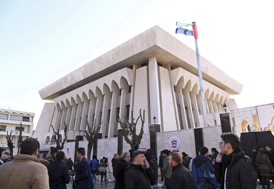 FILE - In this Thursday, Dec. 27, 2018 file photo released by the Syrian official news agency SANA, officials and journalists gather outside the embassy of the United Arab Emirates, in Damascus, Syria. Syria said the. Syrian President Bashar Assad has moved closer to being readmitted to the fold of Arab nations, a feat once deemed unthinkable as he brutally crushed a years-long uprising against him. (SANA via AP, File)