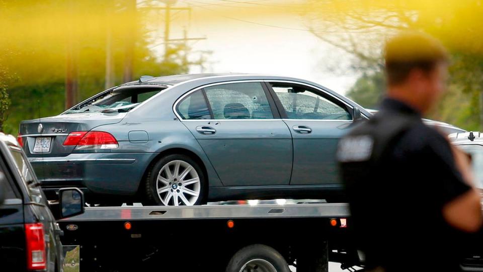Multiple bullet holes are visible in a car that was damaged in a police involved shooting is removed from the scene, Wednesday, April 21, 2021, in Elizabeth City, N.C. A North Carolina deputy shot and killed a man while executing a search warrant Wednesday, the sheriff’s office said. (Stephen M. Katz/The Virginian-Pilot via AP)