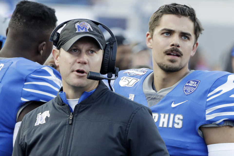 In this Dec. 7, 2019 photo, Memphis deputy head coach Ryan Silverfield, left, watches a replay on the scoreboard with quarterback Brady White, right, during an NCAA college football game between Memphis and Cincinnati for the American Athletic Conference championship in Memphis, Tenn. Silverfield was named head coach Friday, Dec. 13, after after Mike Norvell accepted the head coach position at Florida State. (AP Photo/Mark Humphrey)