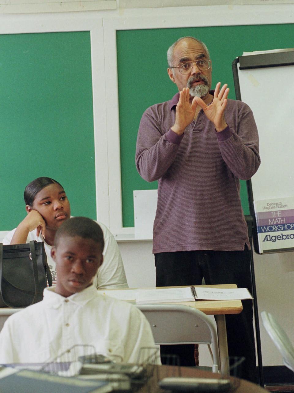 FILE - In this April 6, 1990 file photo, Robert "Bob" Moses teaches an algebra class at Lanier High School in Jackson, Miss. Moses, a civil rights activist who endured beatings and jail while leading Black voter registration drives in the American South during the 1960s and later helped improve minority education in math, died Sunday, July 25, 2021, in Hollywood, Fla. He was 86. (AP Photo/Rogelio Solis, File)