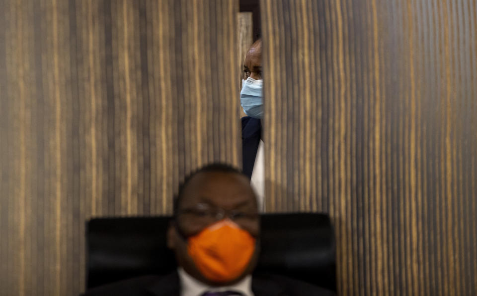 A government official looks on during a media conference for the handing over of the emergency medical equipment for COVID-19 by China, at OR Tambo Johannesburg, South Africa, Tuesday, April 14, 2020. (AP Photo/Themba Hadebe)