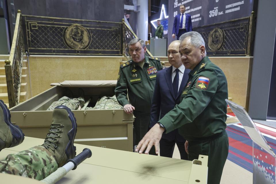 FILE - Russian President Vladimir Putin, center, Russian Chief of General Staff Gen. Valery Gerasimov, left, and Russian Defense Minister Sergei Shoigu visit an exhibition after a meeting with the military brass in Moscow, Russia, on Tuesday, Dec. 19, 2023. Russia has managed to significantly increase the output of its defense industries amid the fighting in Ukraine. (Mikhail Klimentyev, Sputnik, Kremlin Pool Photo via AP, File)