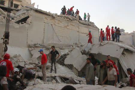 Civilians and rescuers search for survivors at a site hit by airstrikes in Idlib, Syria, September 29, 2016. REUTERS/Ammar Abdullah