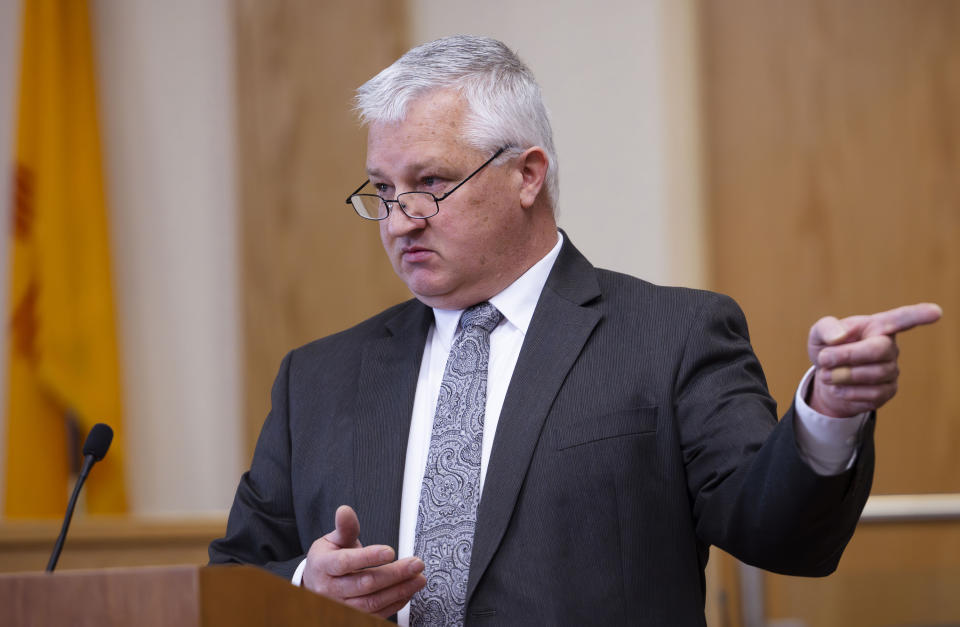 Prosecutor David Waymire points to Muhammad Syed during opening statements to the jury at the Bernalillo County District Courthouse in Downtown Albuquerque, N.M,, on Tuesday, March 12, 2024. Syed, an Afghan refugee, is accused in the slayings of three Muslim men in Albuquerque. (Chancey Bush/The Albuquerque Journal via AP, Pool)