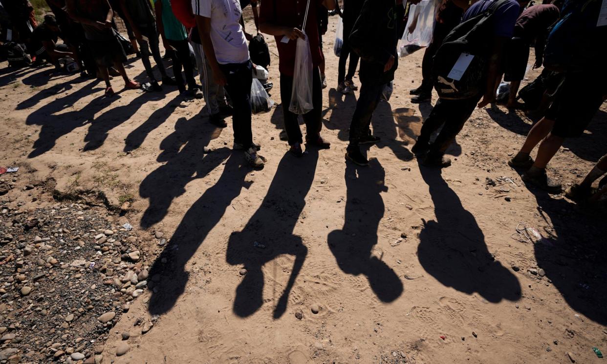 <span>People at the border wait to have their applications processed by US officials.</span><span>Photograph: Eric Gay/AP</span>