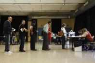 People queue to vote in Spain's municipal and regional elections at a polling station in Barcelona on May 24, 2015