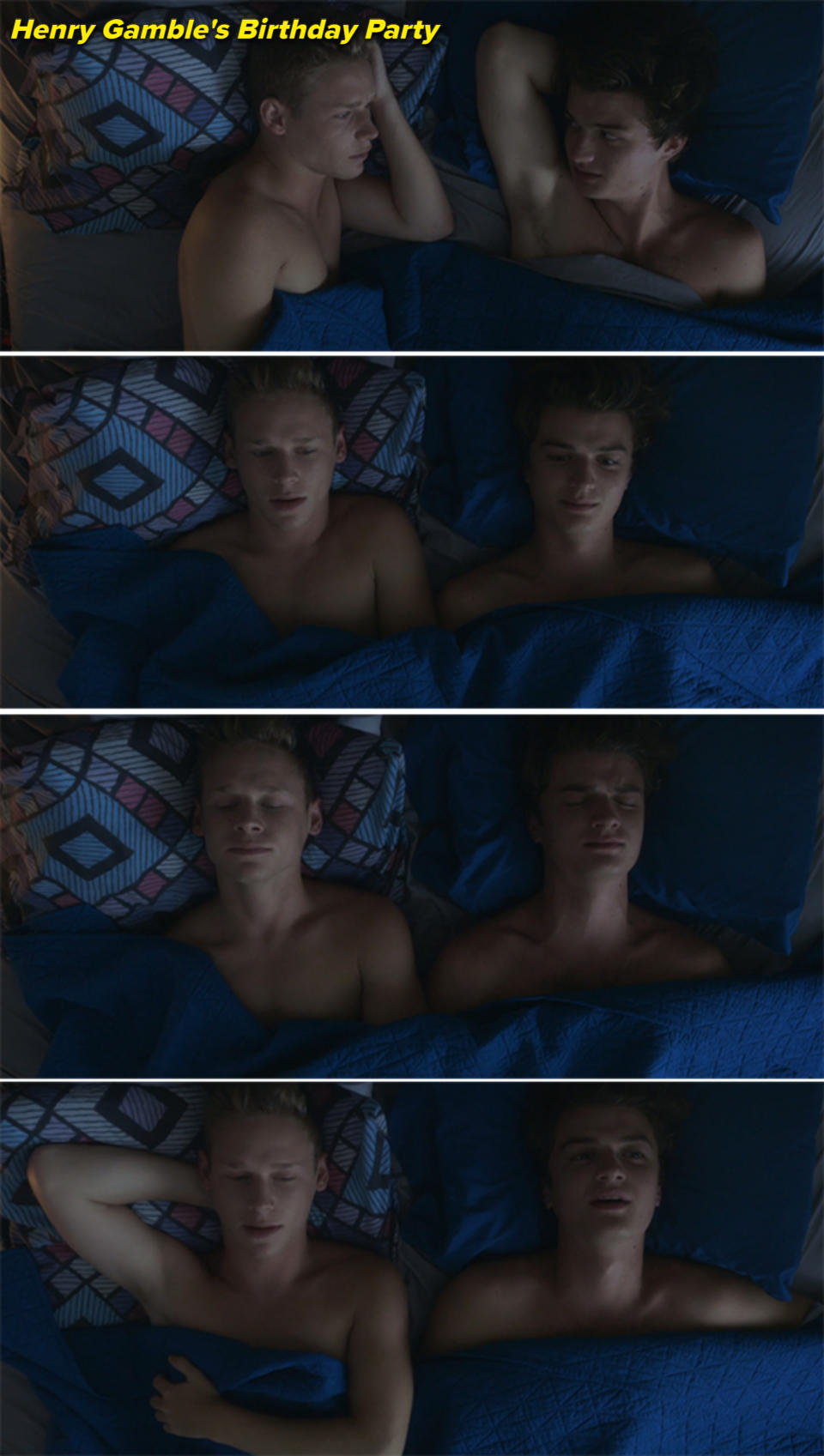 Two shirtless men, one blonde and one brunette, lie together in bed, facing each other and then lying on their backs, sharing a quiet and intimate moment