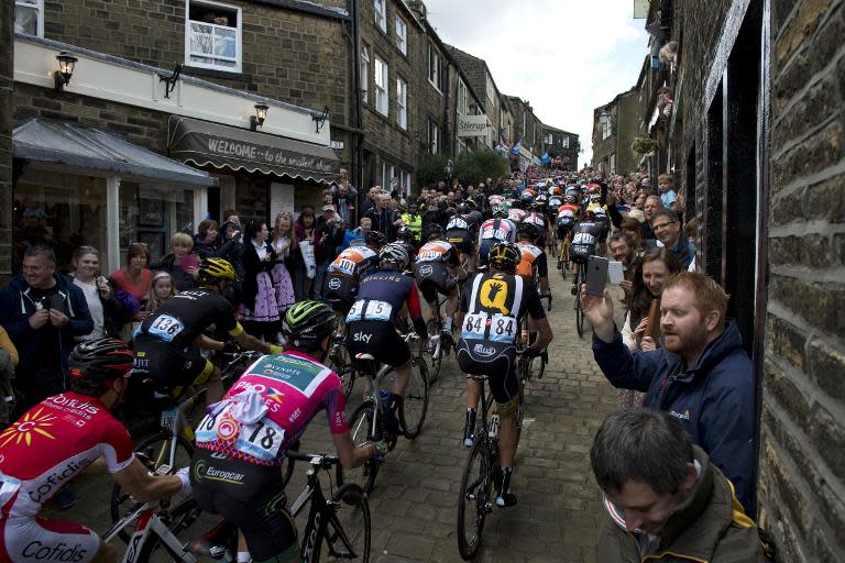 Cylists ride on a cobblestone street through the village of Haworth as they take part on the third and final day of the inaugural Tour de Yorkshire in Haworth on May 3, 2015