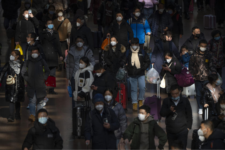 FILE - Travelers walk along a concourse at Beijing West Railway Station in Beijing, Jan. 18, 2023. India will soon surpass China's population. (AP Photo/Mark Schiefelbein, File)