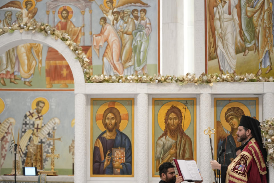 Bishop Apostolos of Medeia, right, participates in a service at St. Nicholas Greek Orthodox Church in New York, Tuesday, Dec. 6, 2022. After a rebuilding process that lasted more than two decades, the Greek Orthodox church that was destroyed in the Sept. 11 attacks has reopened at the World Trade Center site. The St. Nicholas Greek Orthodox Church and National Shrine, designed by architect Santiago Calatrava, now overlooks the Trade Center memorial pools from an elevated park. (AP Photo/Seth Wenig)