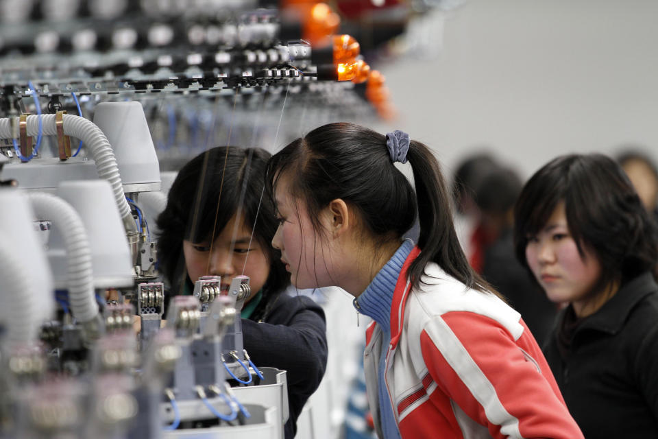 In this Jan. 30, 2012 photo, women work with machines inside a factory that produces stockings in Pyongyang, North Korea. (AP Photo/Kim Kwang Hyon)