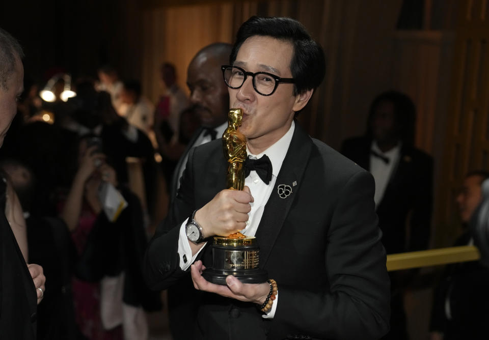 Ke Huy Quan kisses his award for best performance by an actor in a supporting role for "Everything Everywhere All at Once" at the Governors Ball after the Oscars on Sunday, March 12, 2023, at the Dolby Theatre in Los Angeles. (AP Photo/John Locher)