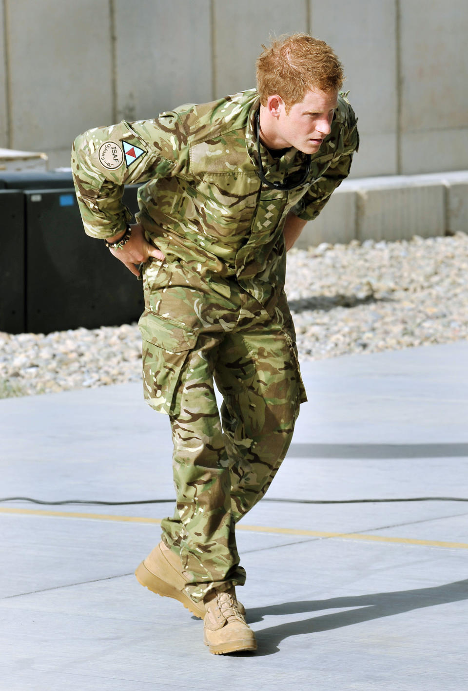 Britain's Prince Harry examines the 30mm cannon of an Apache helicopter Friday Sept 7 2012 at Camp Bastion in Afghanistan, where he will be operating from during his tour of duty as a co-pilot gunner. The Prince has returned to Afghanistan to fly attack helicopters in the fight against the Taliban. (AP Photo/ John Stillwell, Pool)