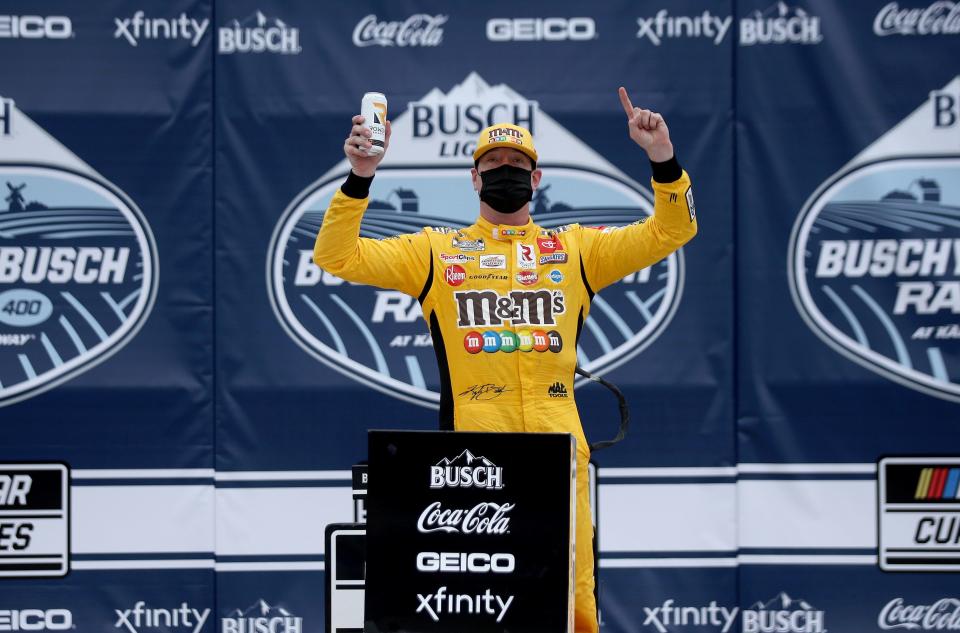 Kyle Busch celebrates in victory lane after winning the Buschy McBusch Race 400 at Kansas Speedway.