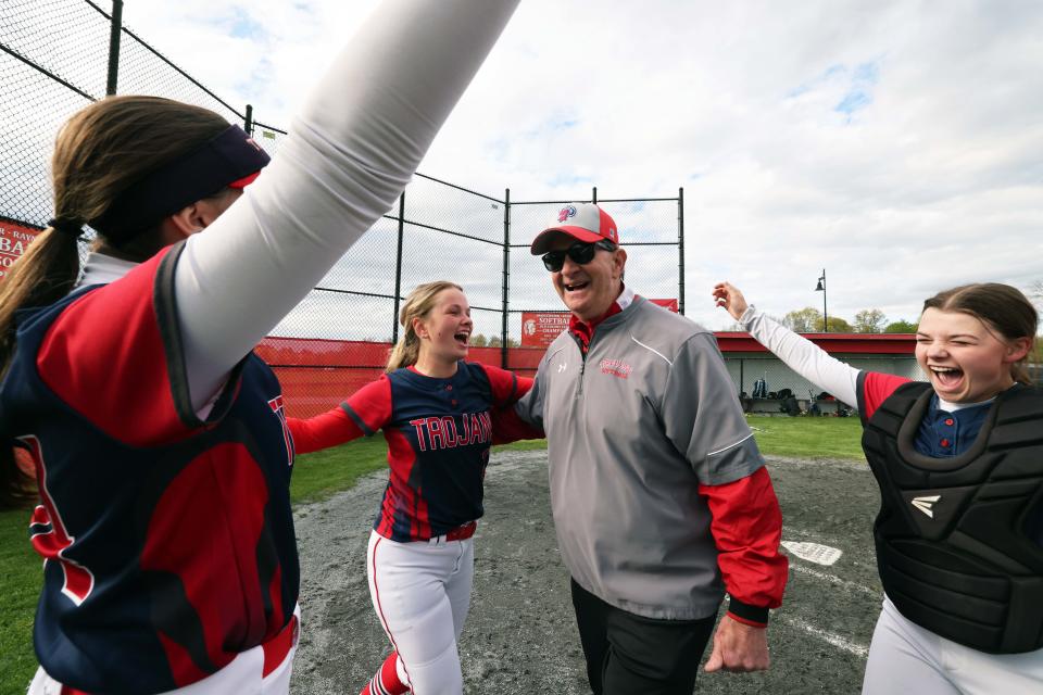 Bridgewater-Raynham head coach Mike Carrozza celebrates with players Emma Flaherty, Taylor Reid and teammates after he won his 400th career game versus Brockton on Wednesday, May 3, 2023. 