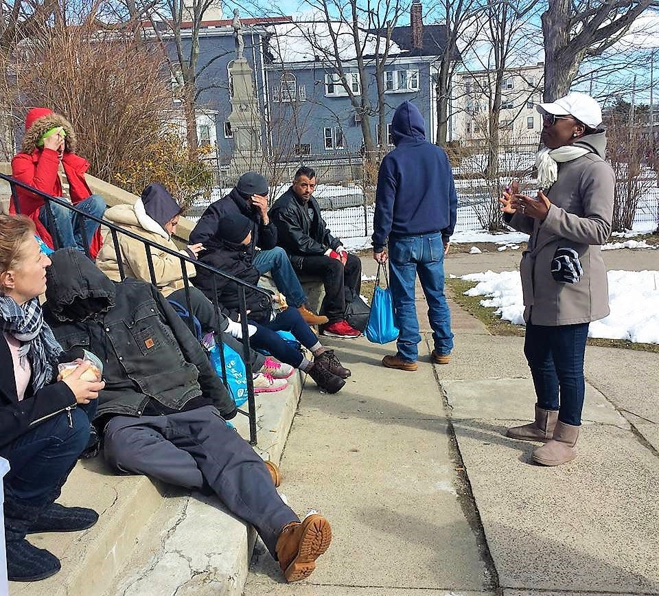 Lovern Gordon, left, speaks to a group of homeless people near Boston. Gordon, a survivor of domestic abuse and founder of the Love Life Now Foundation, said that reaching out to others is the best way to overcome trauma. She is skeptical, however, that communities of color will have the resources needed in the wake of COVID-19's devastating effect on their communities.