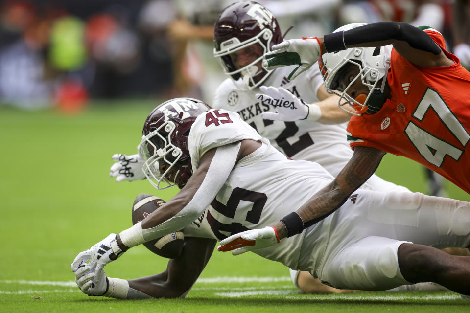 Sep 9, 2023; Miami Gardens, Florida; Texas A&M Aggies linebacker Edgerrin Cooper (45) recovers a fumble against the Miami Hurricanes during the second quarter at Hard Rock Stadium. Sam Navarro-USA TODAY Sports