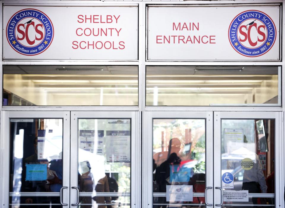 School administrators look out the front doors on Wednesday, Sept. 16, 2020.