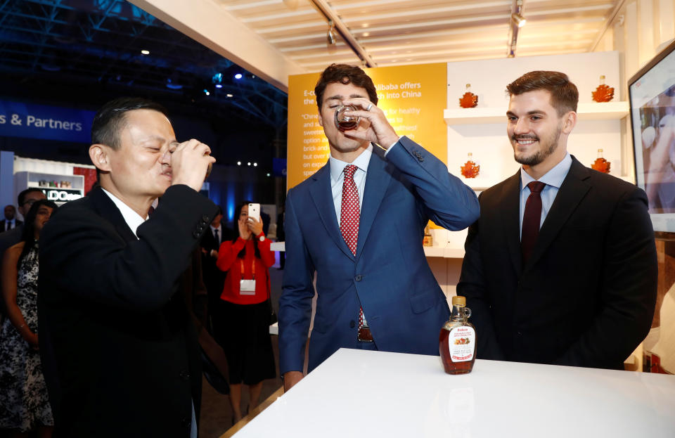 Canada&#39;s Prime Minister Justin Trudeau and Alibaba founder Jack Ma try a sample of maple syrup as they tour the marketplace at the Gateway Conference in Toronto, Ontario, Canada September 25, 2017.    REUTERS/Mark Blinch
