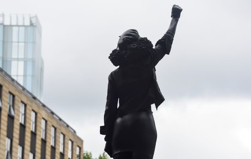 A sculpture of a Black Lives Matter protester stands on the empty plinth previously occupied by the statue of slave trader Edward Colston, in Bristol