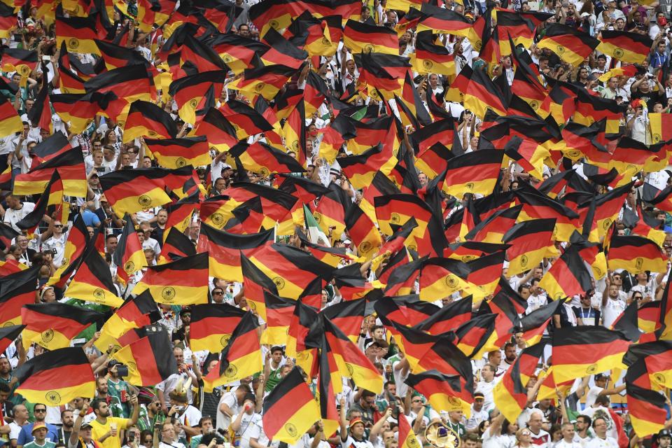 <p>Germany’s fans wave German national flags as they cheer prior to the Russia 2018 World Cup Group F football match between Germany and Mexico at the Luzhniki Stadium in Moscow on June 17, 2018. (Photo by PATRIK STOLLARZ / AFP) </p>