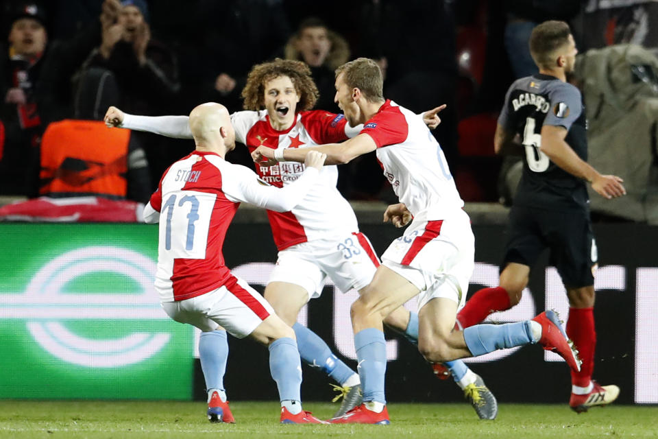 Teammates celebrate with Slavia's Tomas Soucek, center right, who scored his side's second goal with a penalty during their Europa League Round of 16 second leg soccer match between Slavia Praha and Sevilla at the Sinobo stadium in Prague, Czech Republic, Thursday, March 14, 2019. (AP Photo/Petr David Josek)
