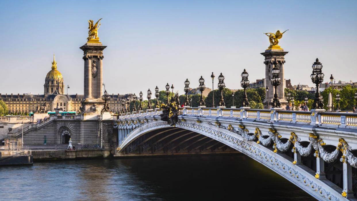 bridge alexandre iii over seine river against clear blue sky in paris, france