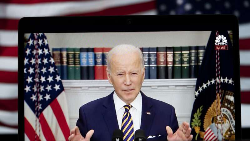 Joe Biden speaking at a microphone