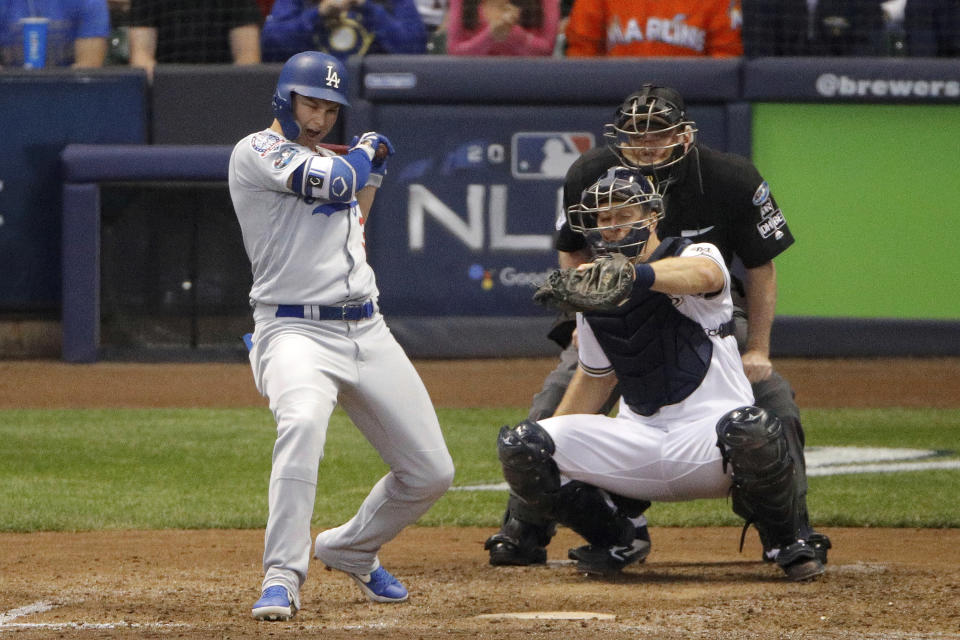 Los Angeles Dodgers' Joc Pederson (31) reacts after getting hit by a pitch during the sixth inning of Game 6 of the National League Championship Series baseball game against the Milwaukee Brewers Friday, Oct. 19, 2018, in Milwaukee. (AP Photo/Charlie Riedel)