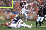 Cleveland Browns running back Kareem Hunt (27) jumps over players during the first half of an NFL football game against the Chicago Bears, Sunday, Sept. 26, 2021, in Cleveland. (AP Photo/David Dermer)