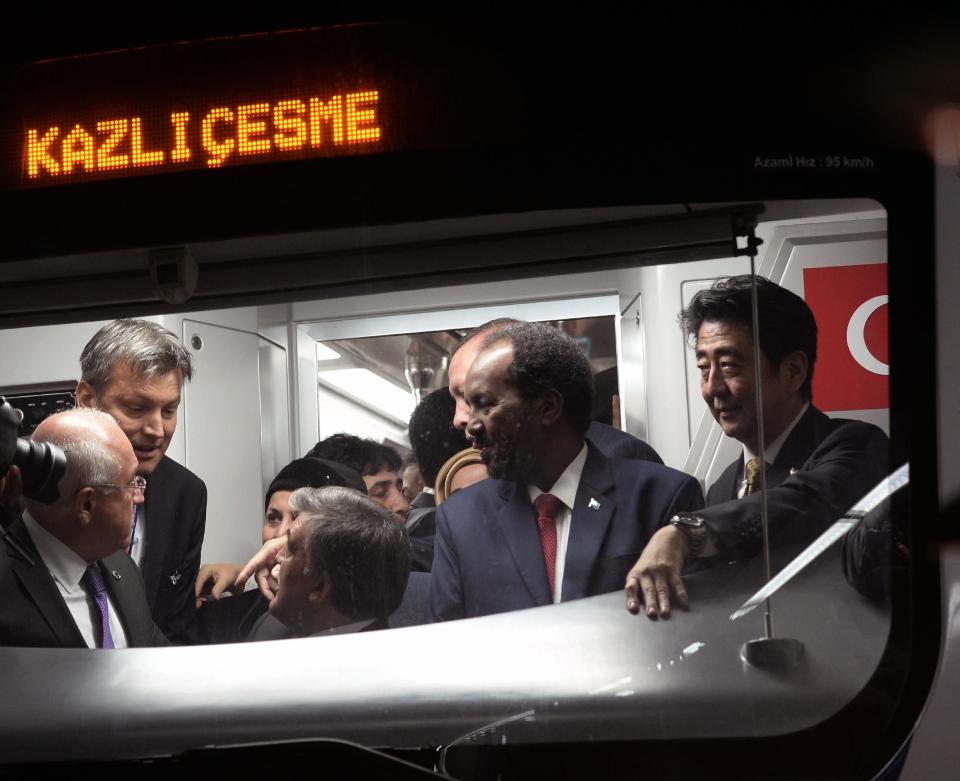 Japanese Prime Minister Shinzo Abe, right, and other dignitaries wait inside a train to cross the Bosporus after the inauguration of the tunnel called Marmaray in Istanbul, Turkey, Tuesday, Oct. 29, 2013. Turkey is for the first time connecting its European and Asian sides with a railway tunnel set to open Tuesday, completing a plan initially proposed by an Ottoman sultan about 150 years ago. The Marmaray, is among a number of large infrastructure projects under the government of Prime Minister Recep Tayyip Erdogan that have helped boost the economy but also have provoked a backlash of public protest.(AP Photo)