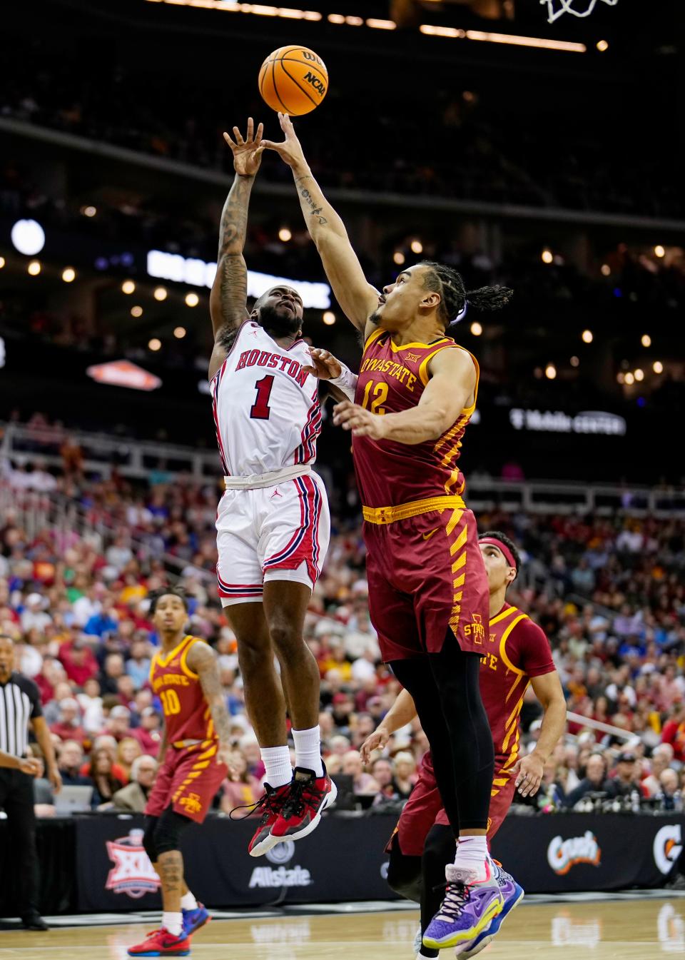 KANSAS CITY, MISSOURI - MARCH 16: Jamal Shead #1 of the Houston Cougars shoots against Robert Jones #12 of the Iowa State Cyclones during the first half of the Big 12 Men's Basketball Tournament championship game at T-Mobile Center on March 16, 2024 in Kansas City, Missouri.  (Photo by Jay Biggerstaff/Getty Images)