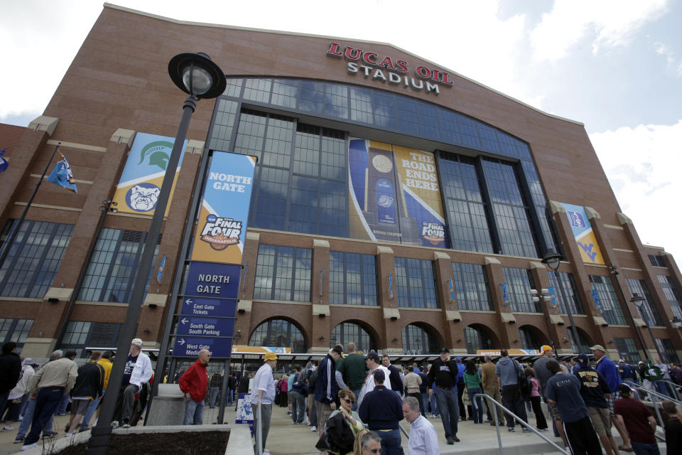 FILE - Fans arrive at Lucas Oil Stadium before a men's NCAA Final Four semifinal college basketball game between Butler and Michigan State in Indianapolis, in this April 3, 2010, file photo. The NCAA announced Monday, Jan. 4, 2021, that all 67 men's basketball tournament games including the Final Four will be played entirely in Indiana in a bid to keep the marquee event from being called off for a second consecutive year because of the coronavirus pandemic. Games will be played on two courts inside Lucas Oil Stadium as well as at Bankers Life Fieldhouse, Hinkle Fieldhouse, Indiana Farmers Coliseum, Mackey Arena at Purdue and Assembly Hall in Bloomington. Only one game at a time will be played at Lucas Oil Stadium.. (AP Photo/Amy Sancetta, File)