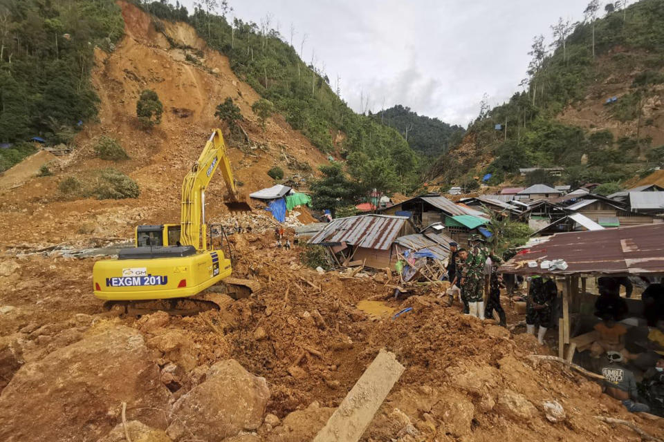 In this photo released by the Indonesian National Search and Rescue Agency (BASARNAS), rescuers search for victims at the site of a landslide in Suwawa on Sulawesi Island, Indonesia, Wednesday, July 10, 2024. Search efforts for those trapped in a deadly landslide intensified Wednesday, with more rescuers deployed to search an unauthorized gold mine on Indonesia's Sulawesi island that saw a number of deaths over the weekend. (BASARNAS via AP)