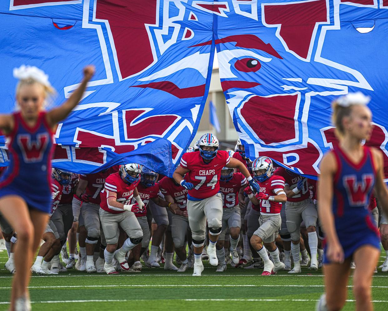 Westlake offensive lineman Tyler Knape, center, leads the Chaparrals onto the field ahead of their game Friday night against Converse Judson. Westlake shut out the visiting Rockets 48-0.