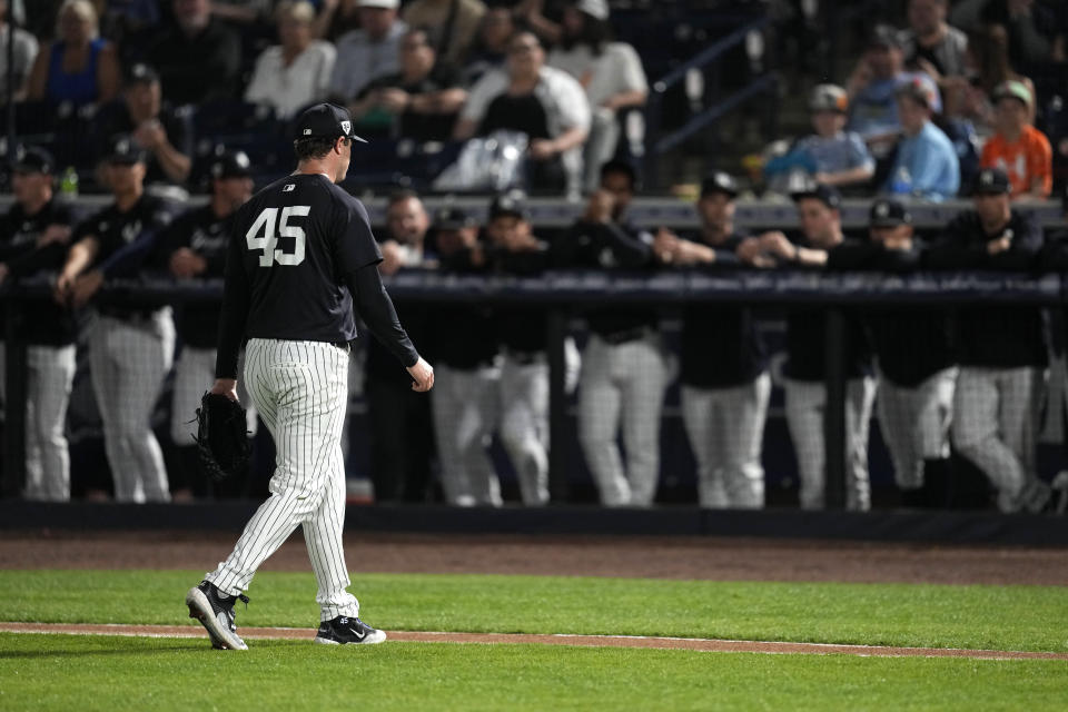 New York Yankees starting pitcher Gerrit Cole (45) walks to the dugout after getting taken out of the game during the first inning of a spring training baseball game against the Toronto Blue Jays Friday, March 1, 2024, in Tampa, Fla. (AP Photo/Charlie Neibergall)