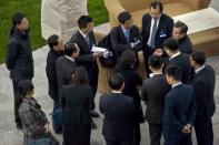 Chinese Foreign Minister Wang Yi (top R) speaks with members of the Chinese delegation at the Beau Rivage Palace Hotel in Lausanne March 31, 2015, where officials are meeting for negotiations on Iran's nuclear program. REUTERS/Brendan Smialowski/Pool