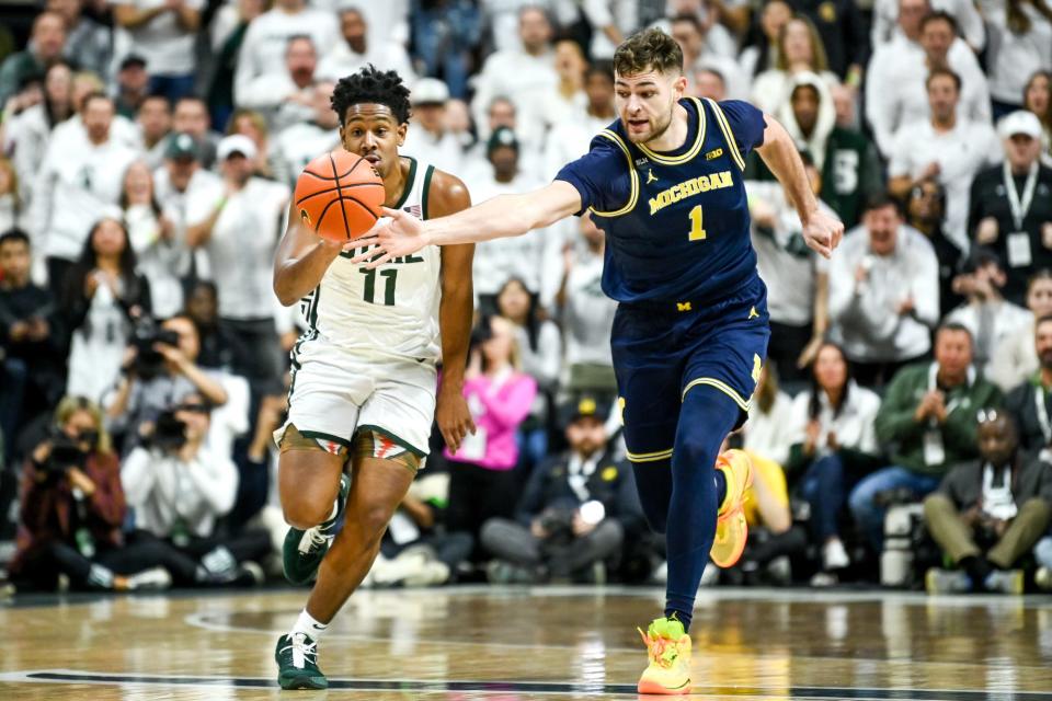 Michigan State's A.J. Hoggard moves past Michigan's Hunter Dickinson during the first half on Saturday, Jan. 7, 2023, at the Breslin Center in East Lansing.