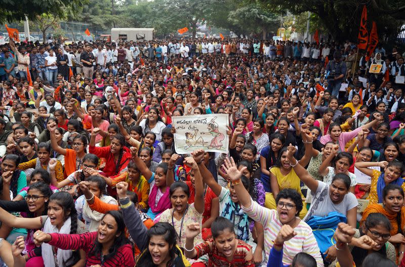 People shout slogans during a protest against the alleged rape and murder of a 27-year-old woman in Hyderabad