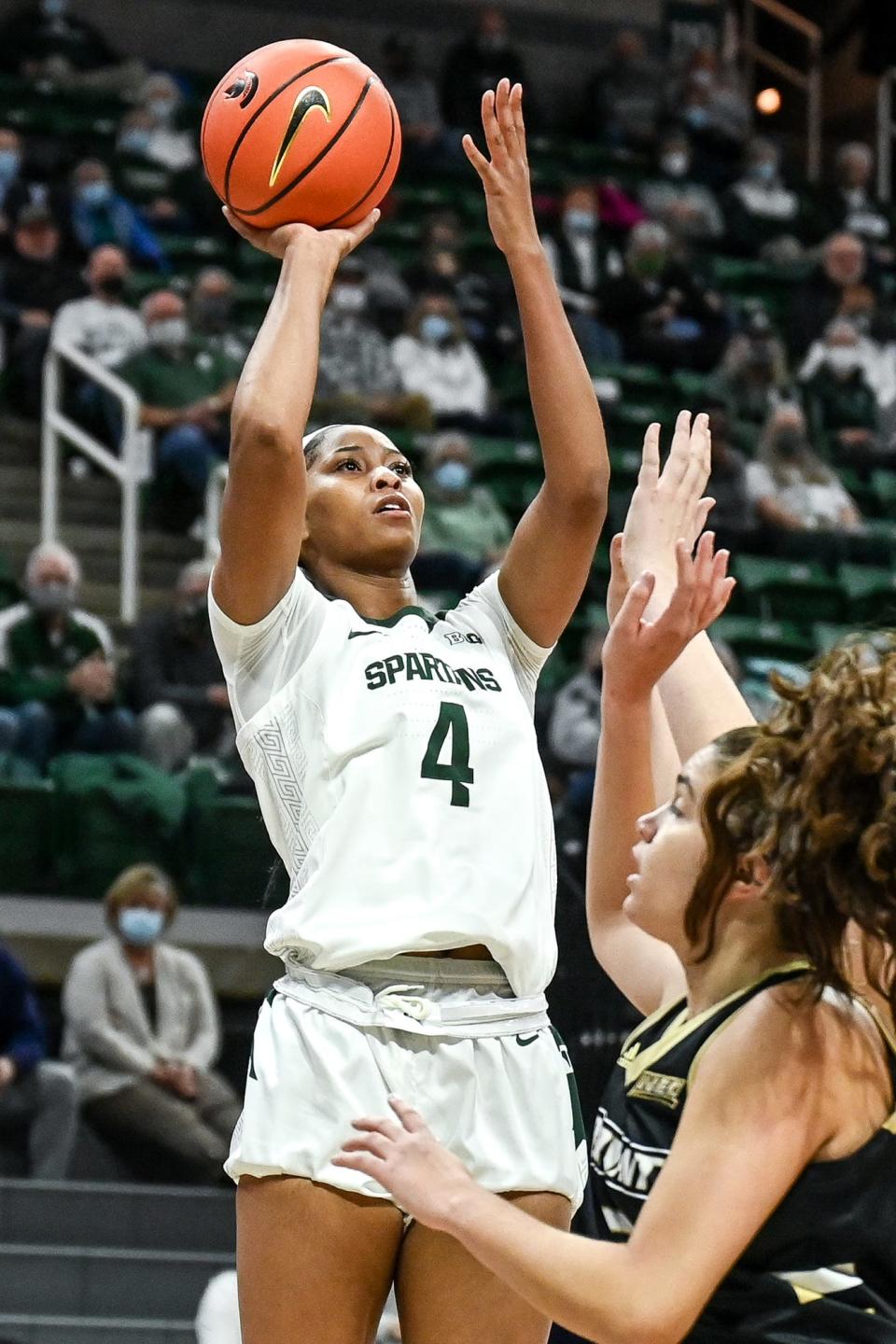 Michigan State's Alisia Smith shoots over Bryant defenders during the first quarter on Friday, Nov. 19, 2021, at the Breslin Center in East Lansing.