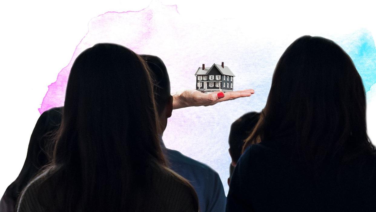 a group of people looking at a building in the snow