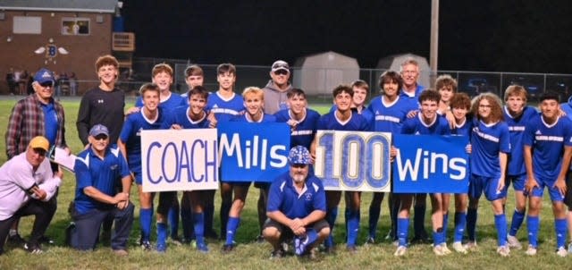 Clear Spring boys soccer coach Lynn Mills celebrated his 100th victory with the team Wednesday night.