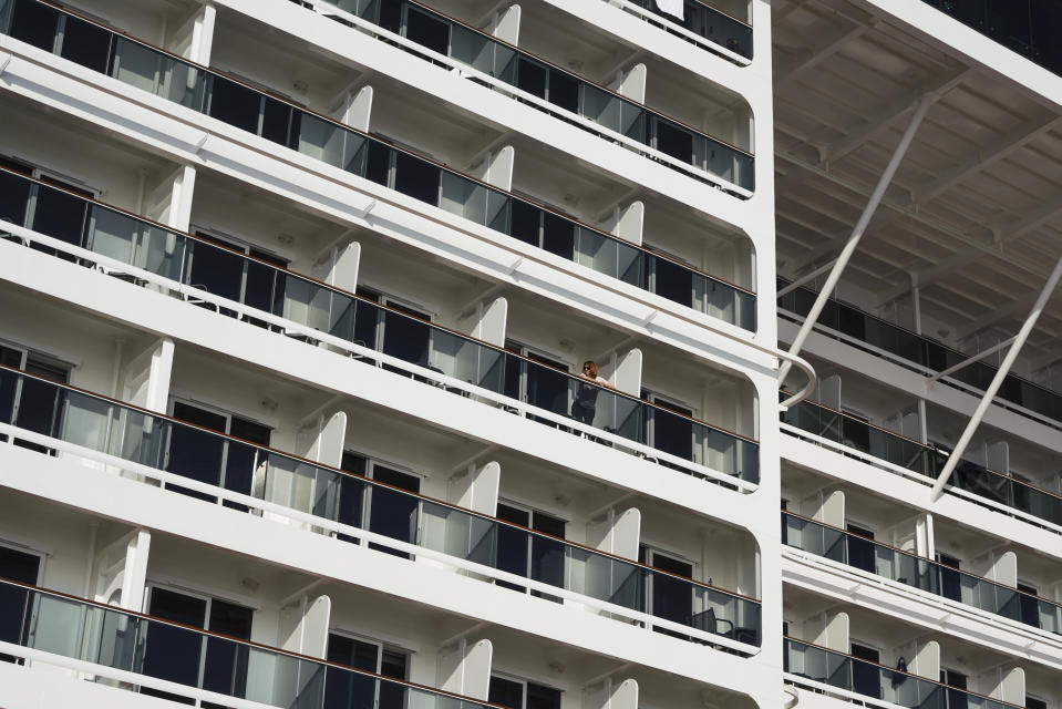 A passenger stand on the terrace of a cabin of the MSC Grandiosa cruise ship in Civitavecchia, near Rome, Wednesday, March 31, 2021. MSC Grandiosa, the world's only cruise ship to be operating at the moment, left from Genoa on March 30 and stopped in Civitavecchia near Rome to pick up more passengers and then sail toward Naples, Cagliari, and Malta to be back in Genoa on April 6. For most of the winter, the MSC Grandiosa has been a lonely flag-bearer of the global cruise industry stalled by the pandemic, plying the Mediterranean Sea with seven-night cruises along Italy’s western coast, its major islands and a stop in Malta. (AP Photo/Andrew Medichini)