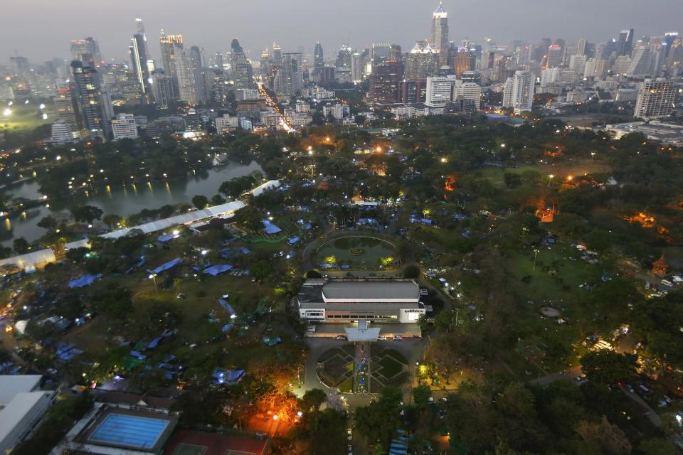 Anti-government protesters' tents are set up inside Lumpini Park, the main protest site in Bangkok in this March 4, 2014 file photo. Viewed from above, with it's sea of blue tarpaulin sheets, Bangkok's Lumpini Park looks like a shelter for victims of a natural disaster. Surrounded by skyscrapers and once a haven for joggers, the Thai capital's most famous park has become the temporary home of more than 10,000 supporters of a movement that's been trying for five months to bring down Prime Minister Yingluck Shinawatra. REUTERS/Damir Sagolj/Files (THAILAND - Tags: POLITICS CIVIL UNREST CITYSCAPE)