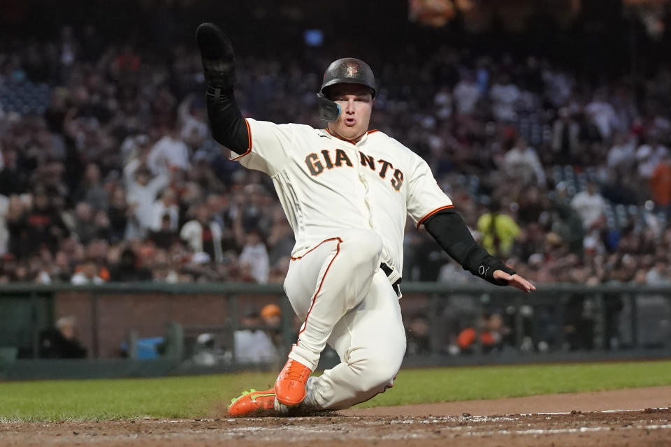San Francisco Giants' Joc Pederson slides home to score against the Tampa Bay Rays during the fifth inning of a baseball game in San Francisco, Monday, Aug. 14, 2023. (AP Photo/Jeff Chiu)