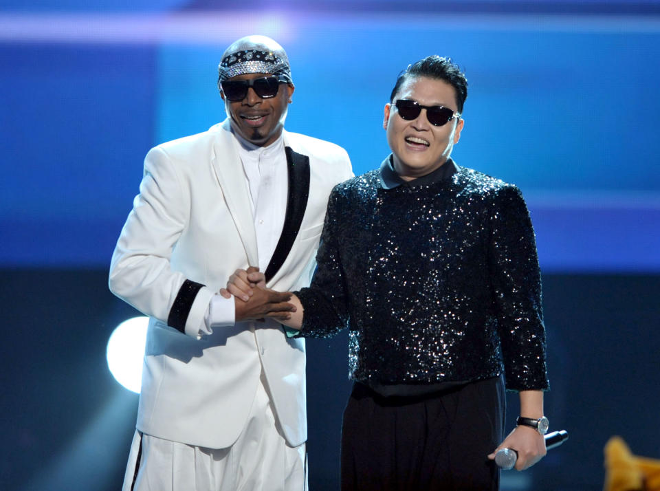 MC Hammer, left, and PSY appear on stage at the close of the 40th Anniversary American Music Awards on Sunday, Nov. 18, 2012, in Los Angeles. (Photo by John Shearer/Invision/AP)