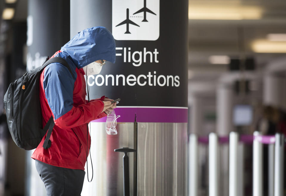 A passenger wearing face mask at a quiet Edinburgh airport during the coronavirus pandemic.