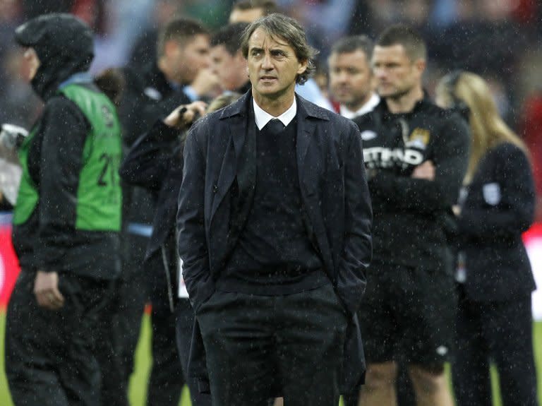 Manchester City's Italian manager Roberto Mancini reacts after his team lost the English FA Cup final football match between Manchester City and Wigan Athletic at Wembley Stadium in London on May 11, 2013